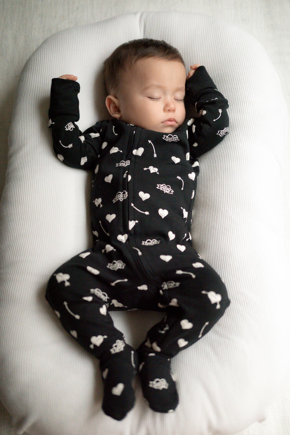 Child wearing Organic 2-Way Zipper Footie in Mom Heart.