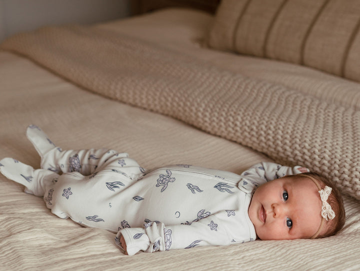 Child wearing Organic 2-Way Zipper Footie in Sea Turtle.