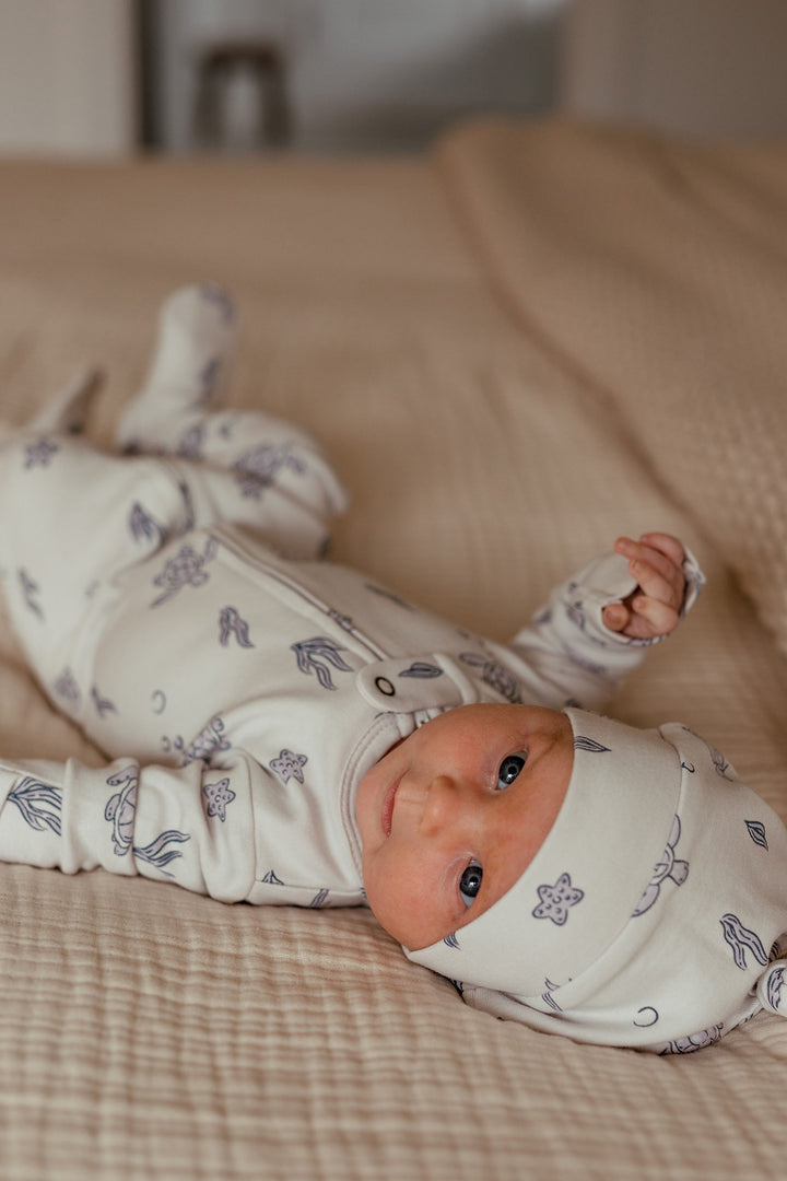 Child wearing Organic 2-Way Zipper Footie in Sea Turtle.