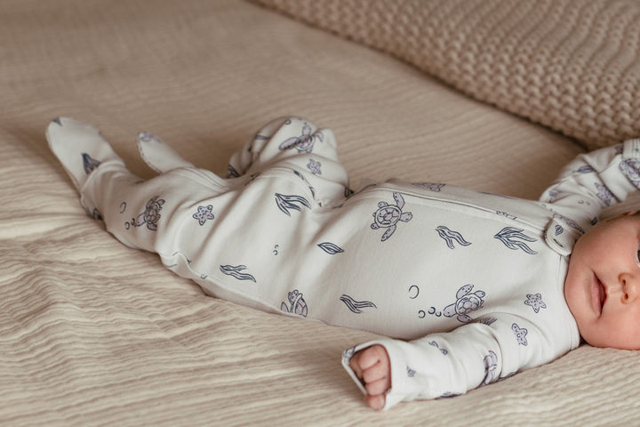 Child wearing Organic 2-Way Zipper Footie in Sea Turtle.