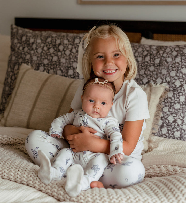 Child wearing Organic 2-Way Zipper Footie in Sea Turtle.