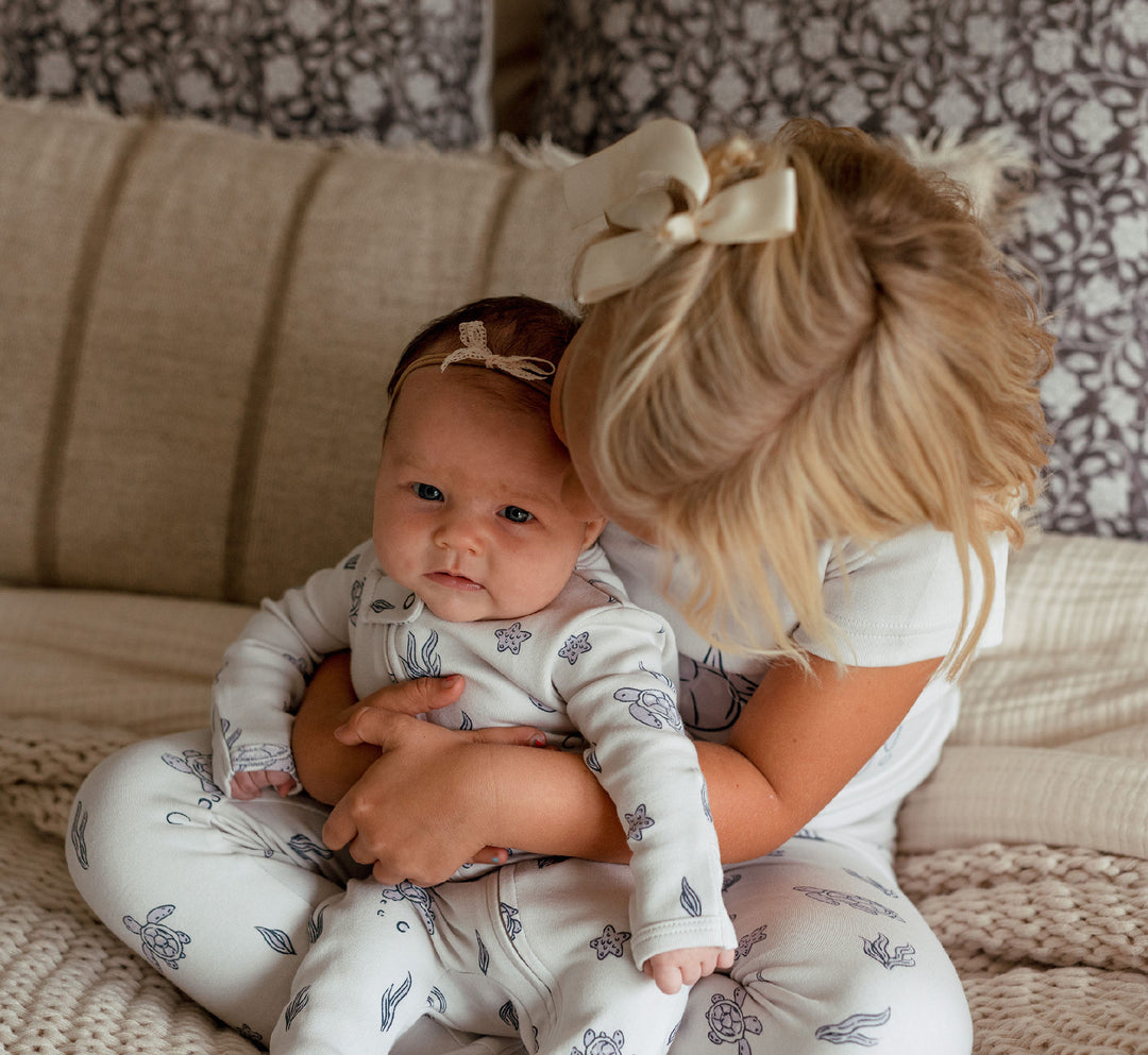 Child wearing Organic 2-Way Zipper Footie in Sea Turtle.