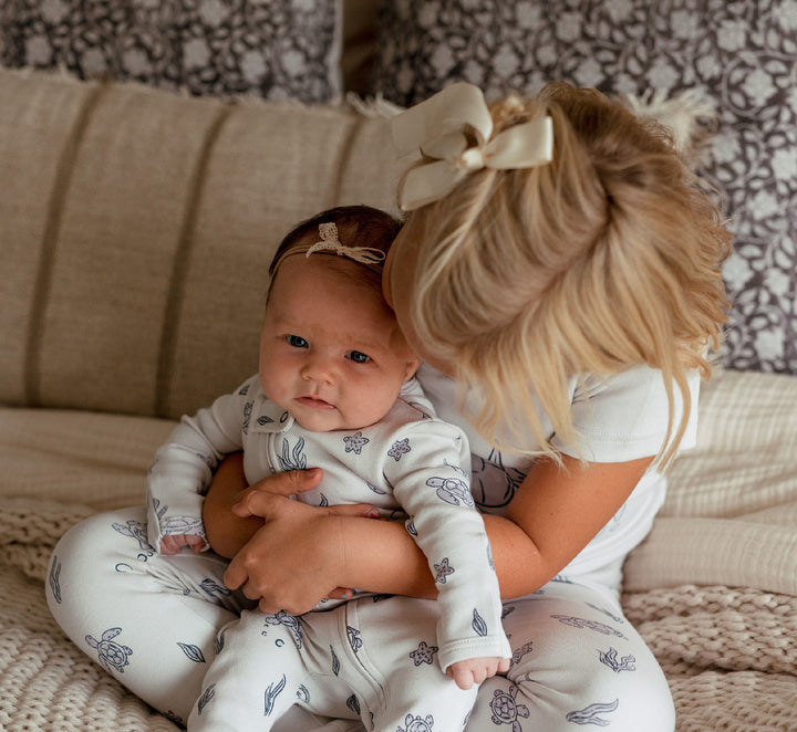 Child wearing Organic 2-Way Zipper Footie in Sea Turtle.