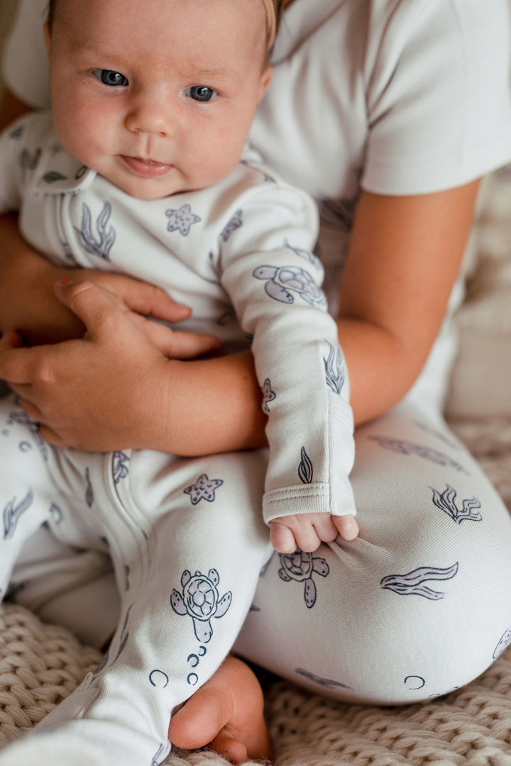 Child wearing Organic 2-Way Zipper Footie in Sea Turtle.