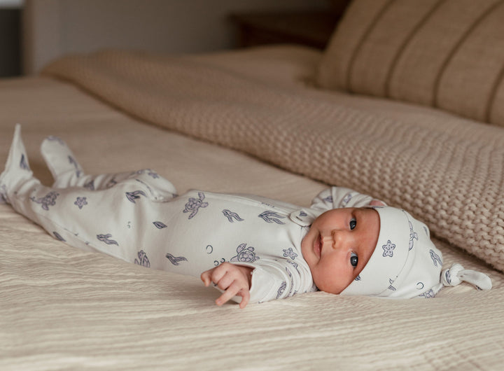 Child wearing Organic 2-Way Zipper Footie in Sea Turtle.