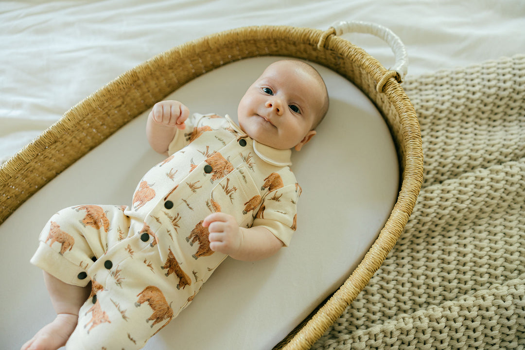 Child wearing Organic S/Sleeve Coverall in Highland Cow.