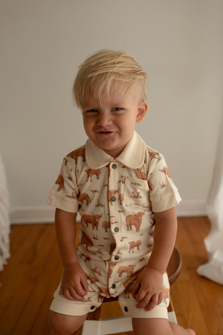 Child wearing Organic S/Sleeve Coverall in Highland Cow.