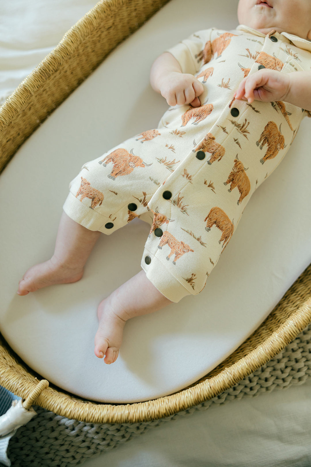 Child wearing Organic S/Sleeve Coverall in Highland Cow.