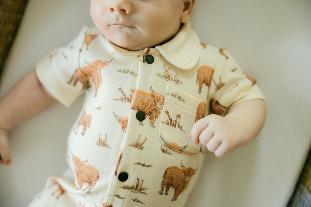 Child wearing Organic S/Sleeve Coverall in Highland Cow.