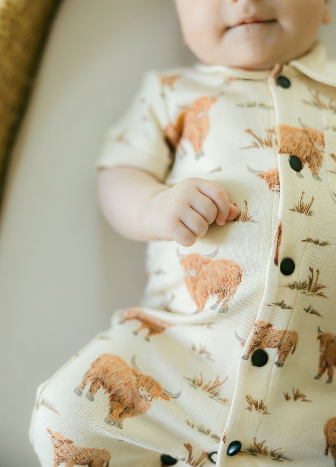 Child wearing Organic S/Sleeve Coverall in Highland Cow.