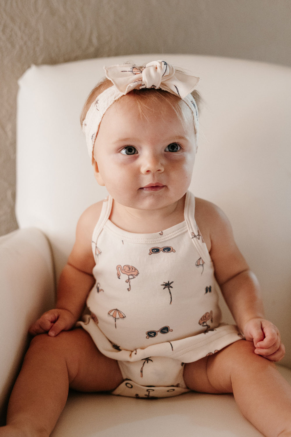 Child wearing Organic Smocked Headband in Flamingo.