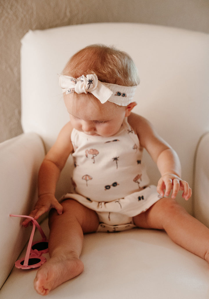 Child wearing Organic Smocked Headband in Flamingo.