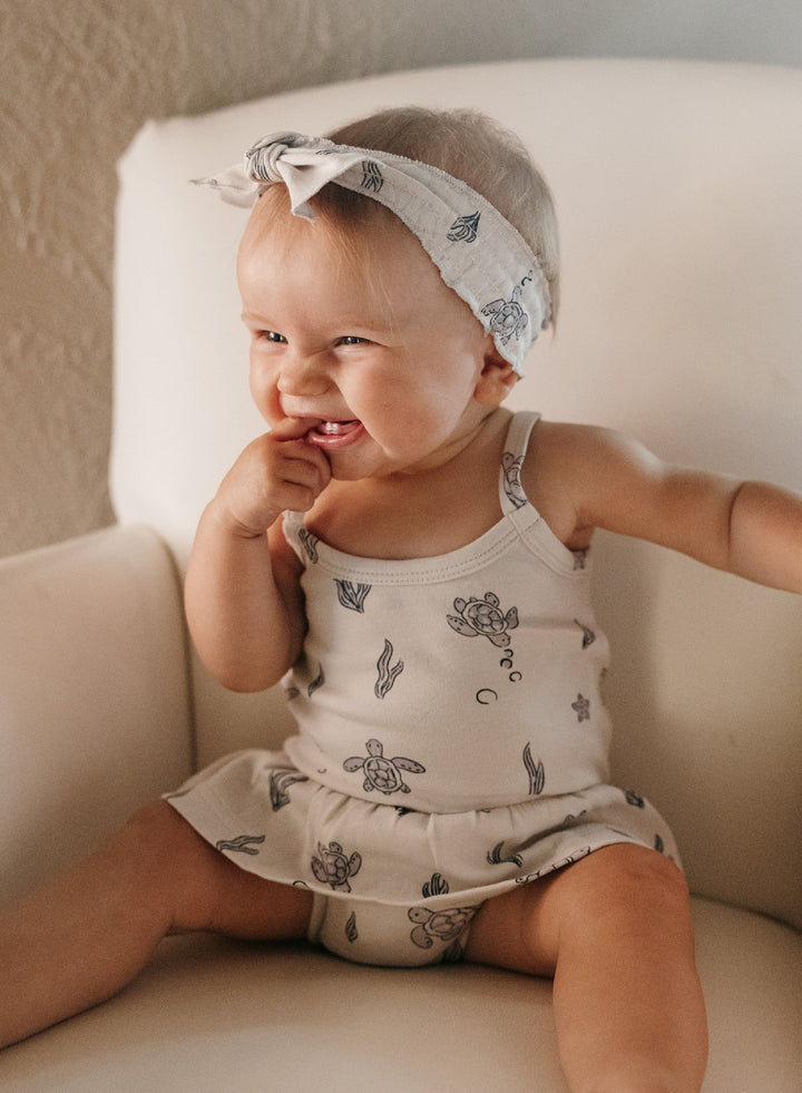 Child wearing Organic Smocked Headband in Sea Turtle.
