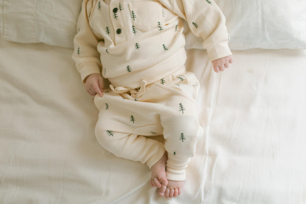 Child wearing Organic Henley Sweatshirt & Jogger Set in Buttercream Tree.