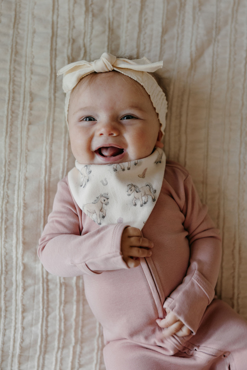 Child wearing Organic Bandana Bib, 2-Pack in Blush Boots.