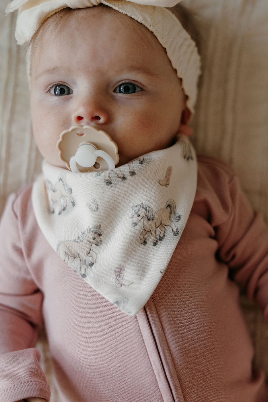 Child wearing Organic Bandana Bib, 2-Pack in Blush Boots.