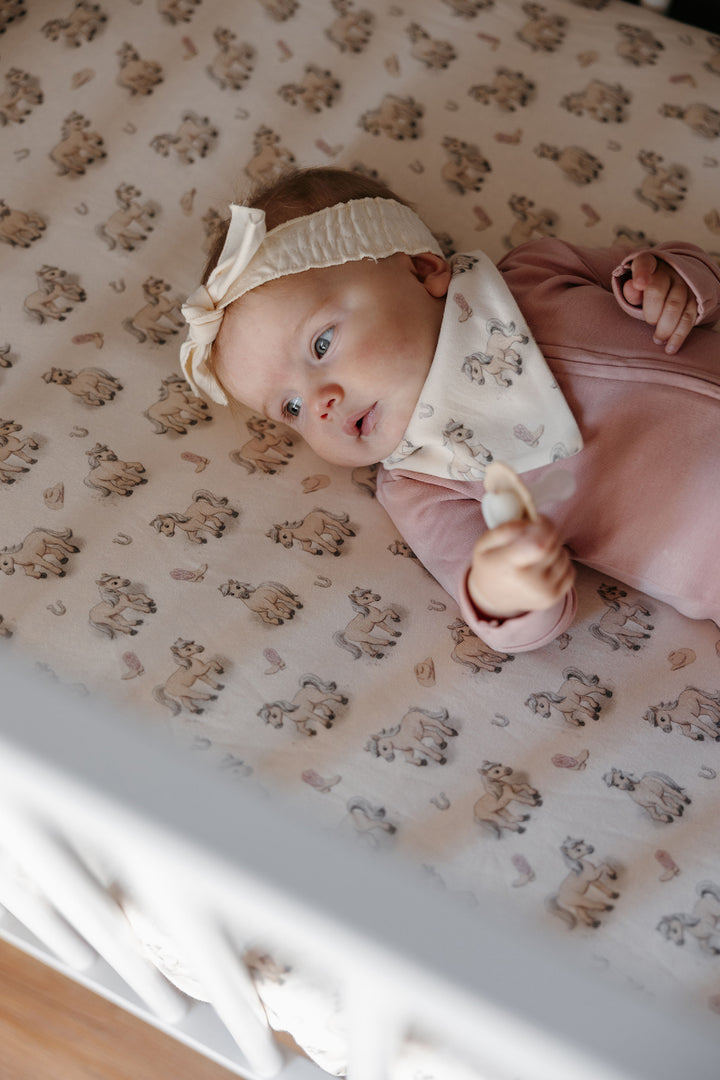Child wearing Organic Bandana Bib, 2-Pack in Blush Boots.