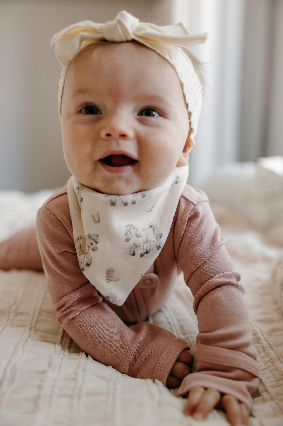 Child wearing Organic Bandana Bib, 2-Pack in Blush Boots.
