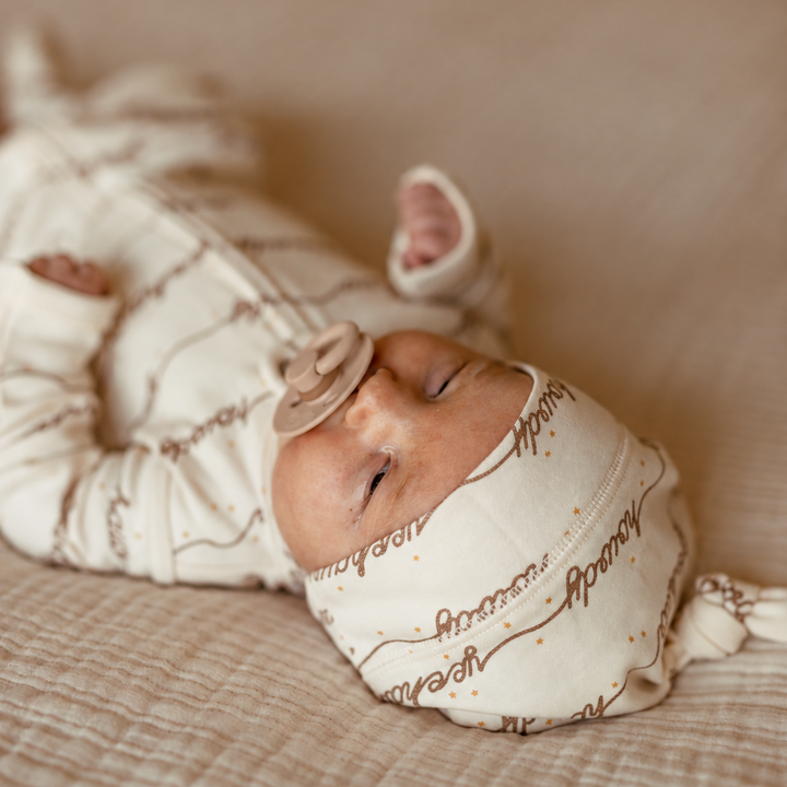 Child wearing an Organic Knotted Hat in Howdy.