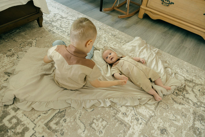 Child wearing Organic Western S/Sleeve Coverall in Oatmeal.