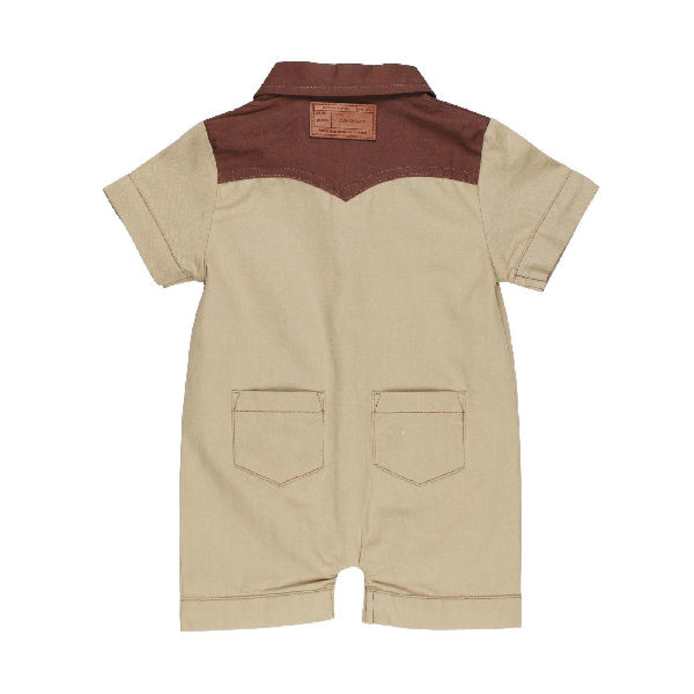 Beige and brown romper with a label on a white background