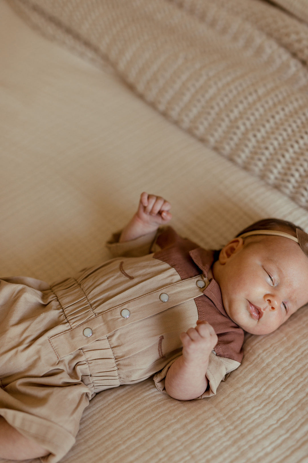 Child wearing Organic Western Romper in Oatmeal.