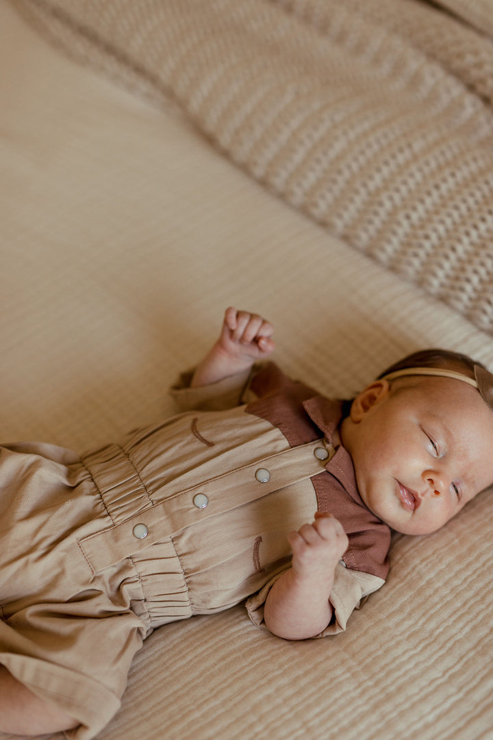 Child wearing Organic Western Romper in Oatmeal.