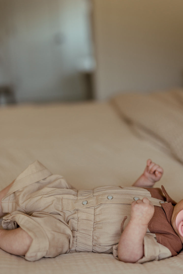 Child wearing Organic Western Romper in Oatmeal.