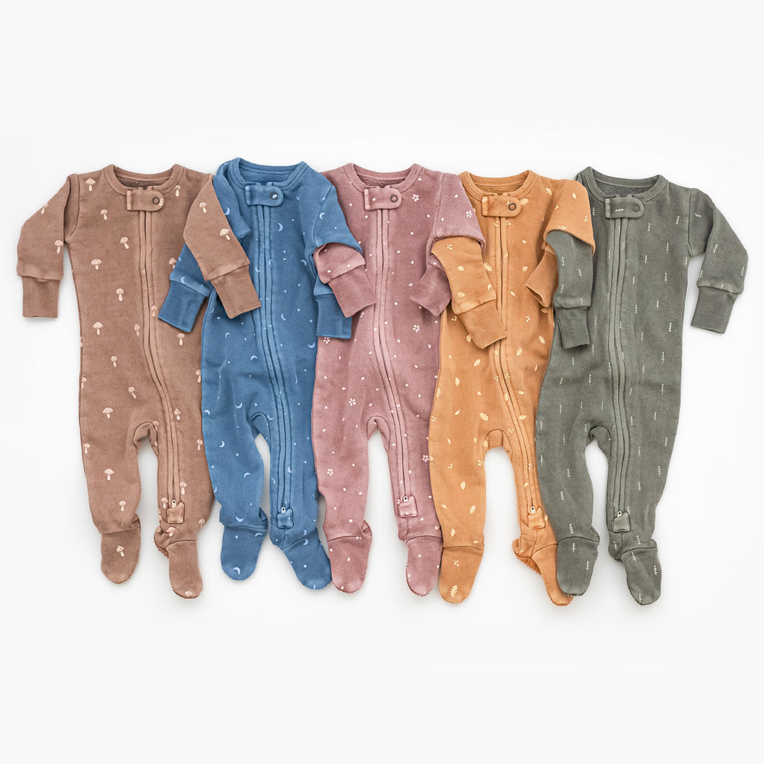 styled flat lay image of multiple footies from the cozy collection in a flattering color array.