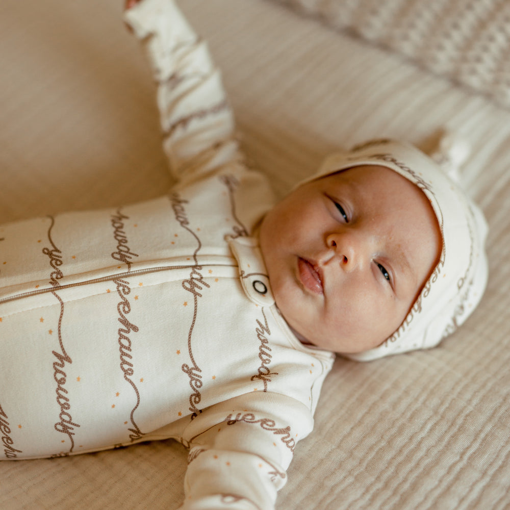 Child wearing an Organic 2-Way Zipper Footie in Howdy