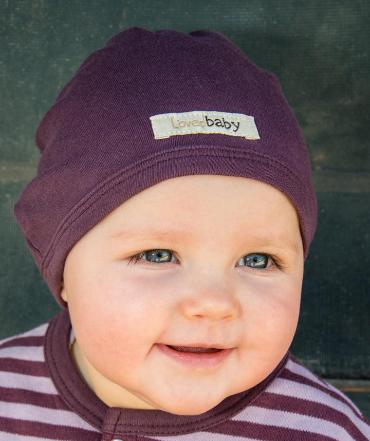 Child wearing Organic Cute Cap in Eggplant.