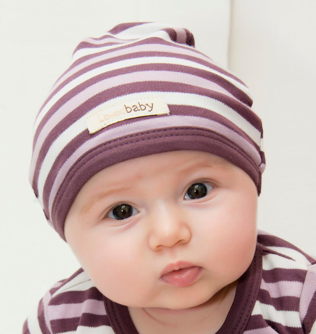 Child wearing Organic Cute Cap in Eggplant Stripe.