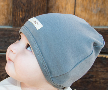 Child wearing Organic Cute Cap in Gray.