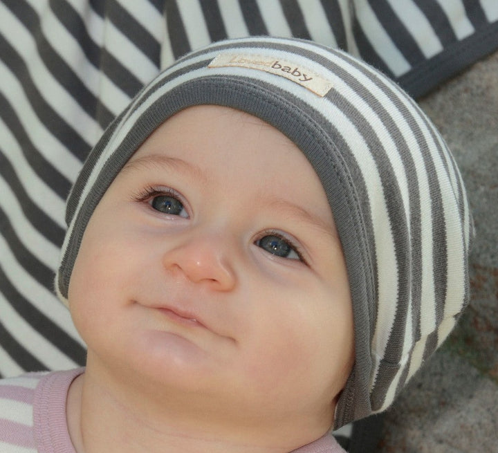 Child wearing Organic Cute Cap in Gray/Beige.