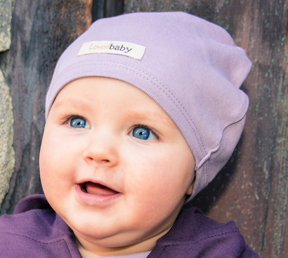 Child wearing Organic Cute Cap in Lavender.