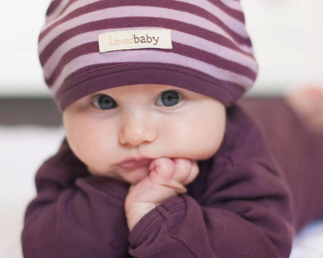 Child wearing Organic Cute Cap in Lavender/Eggplant.