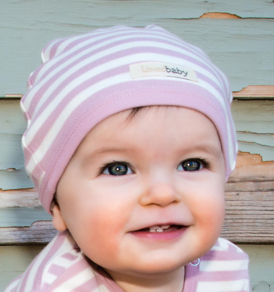 Child wearing Organic Cute Cap in Mauve/Beige.