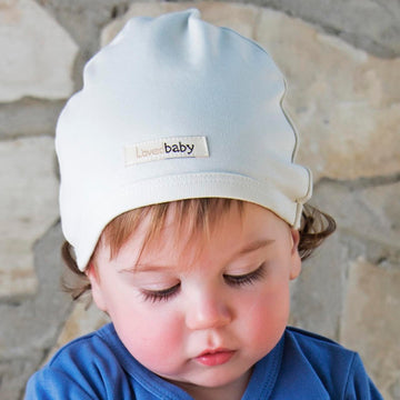 Child wearing Organic Cute Cap in Stone.