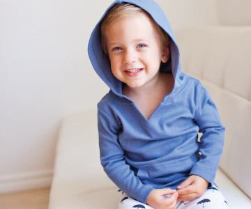 Child wearing Organic Hoodie in Slate.