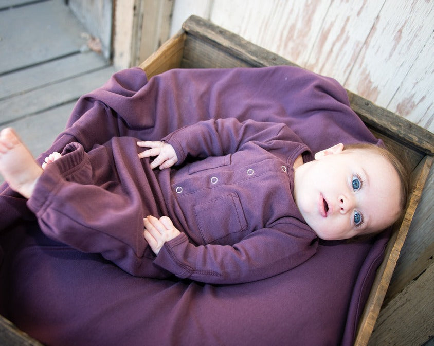 Child wearing Organic Gown in Eggplant.