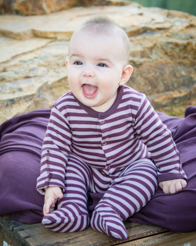 Child wearing Organic Snap Footie in Lavender/Eggplant.