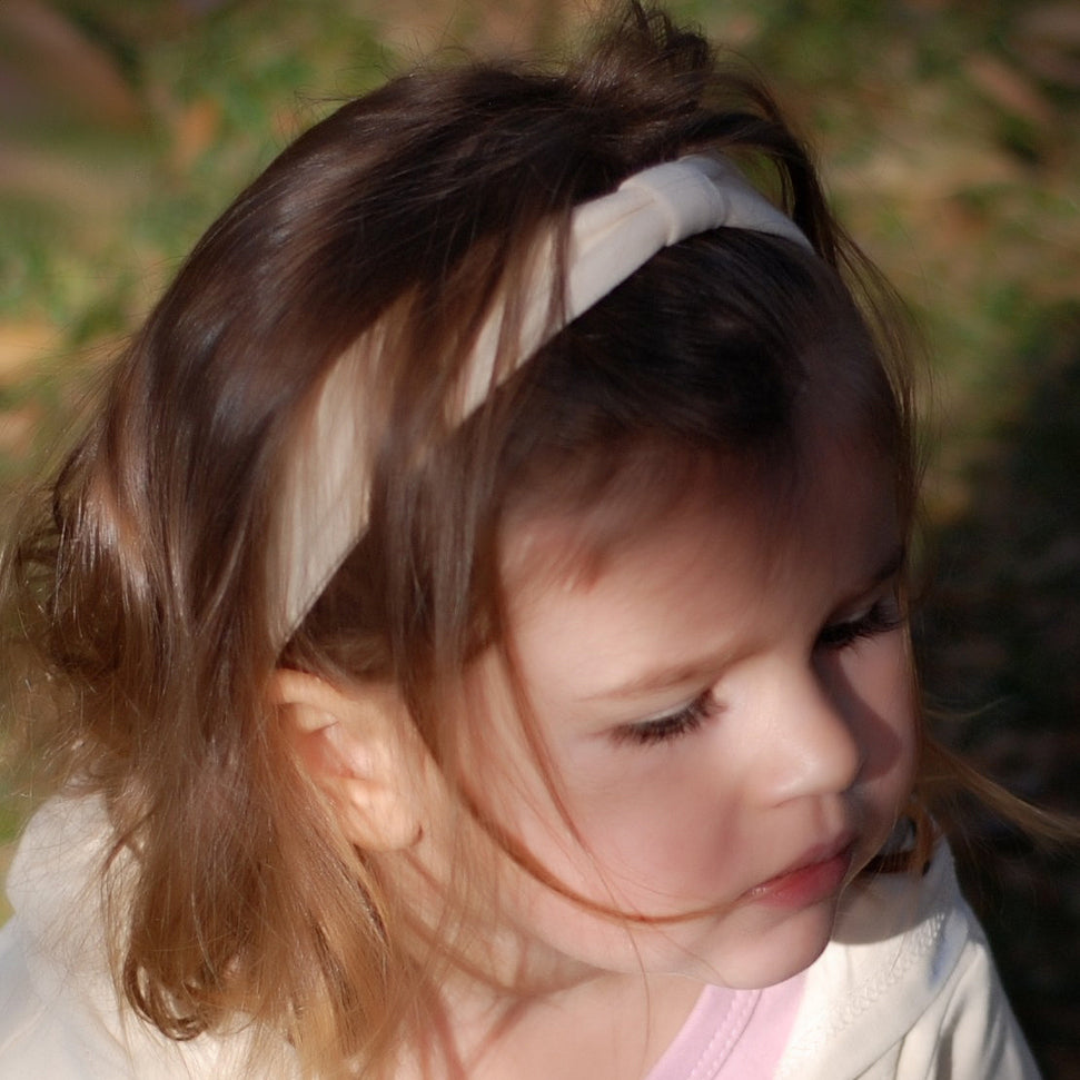 Child wearing Organic Headband in Buttercream.