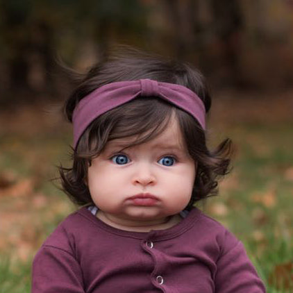 Child wearing Organic Headband in Eggplant.
