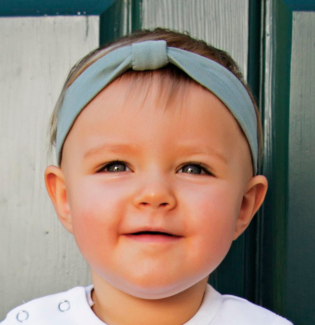 Child wearing Organic Headband in Seafoam.