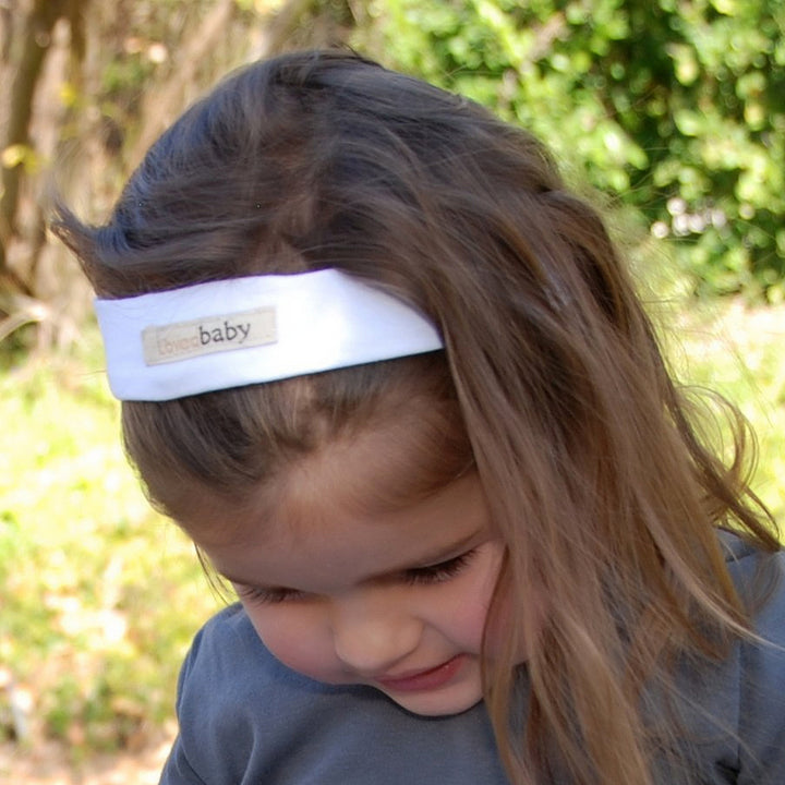 Child wearing Organic Headband in White.