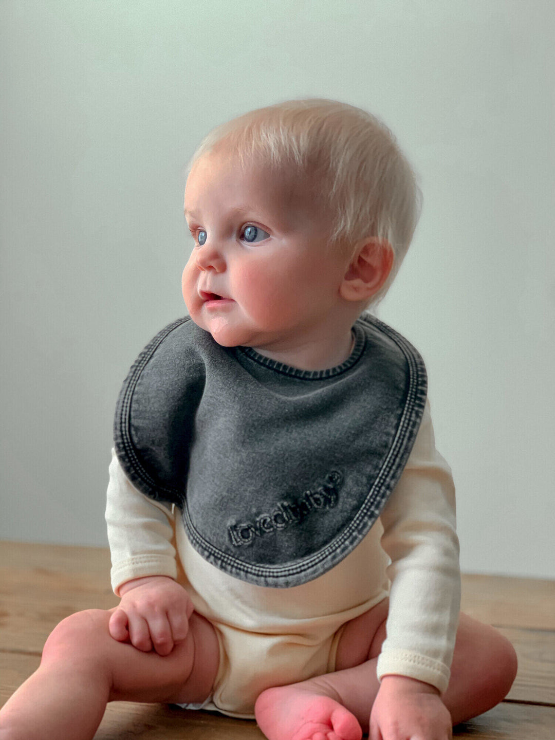 Child wearing Faux Denim Bib in Black.