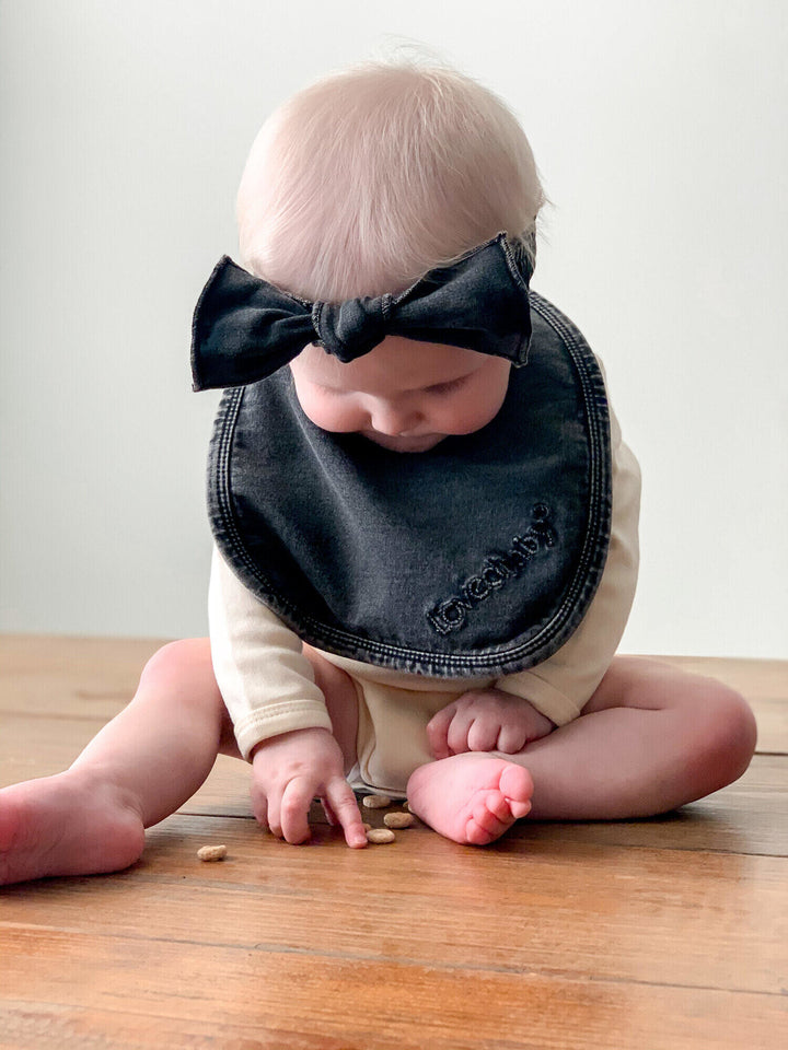 Child wearing Faux Denim Bib in Black.