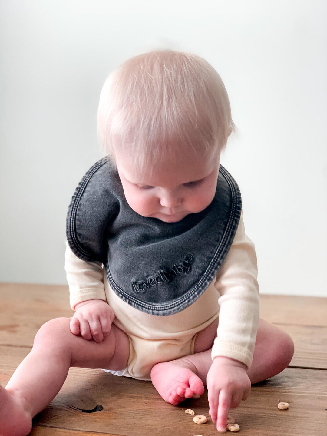 Child wearing Faux Denim Bib in Black.