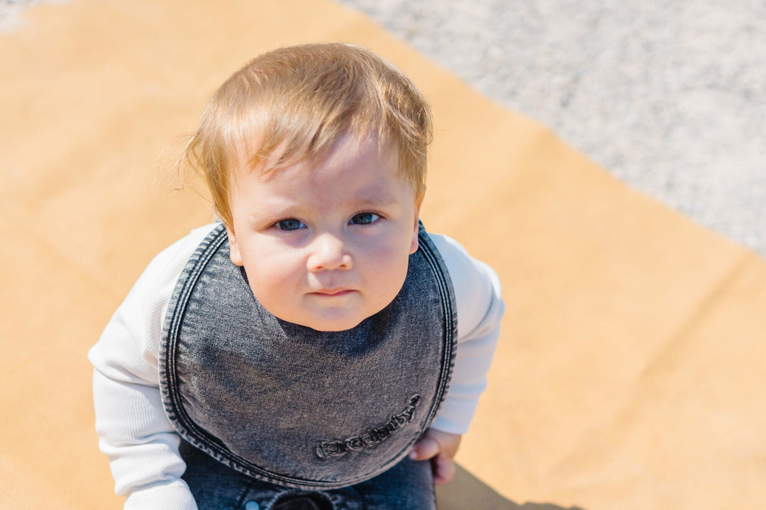 Child wearing Faux Denim Bib in Black.