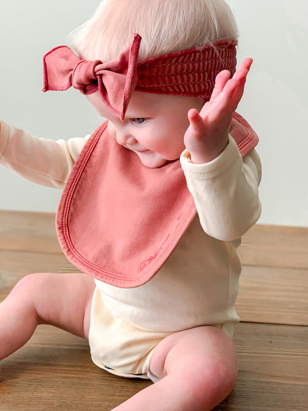 Child wearing Faux Denim Bib in Sienna.